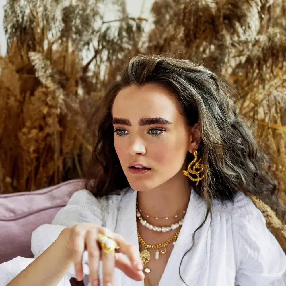 Portrait of a beautiful girl with curly hairBeauty fashion and style, wearing metal jewelry