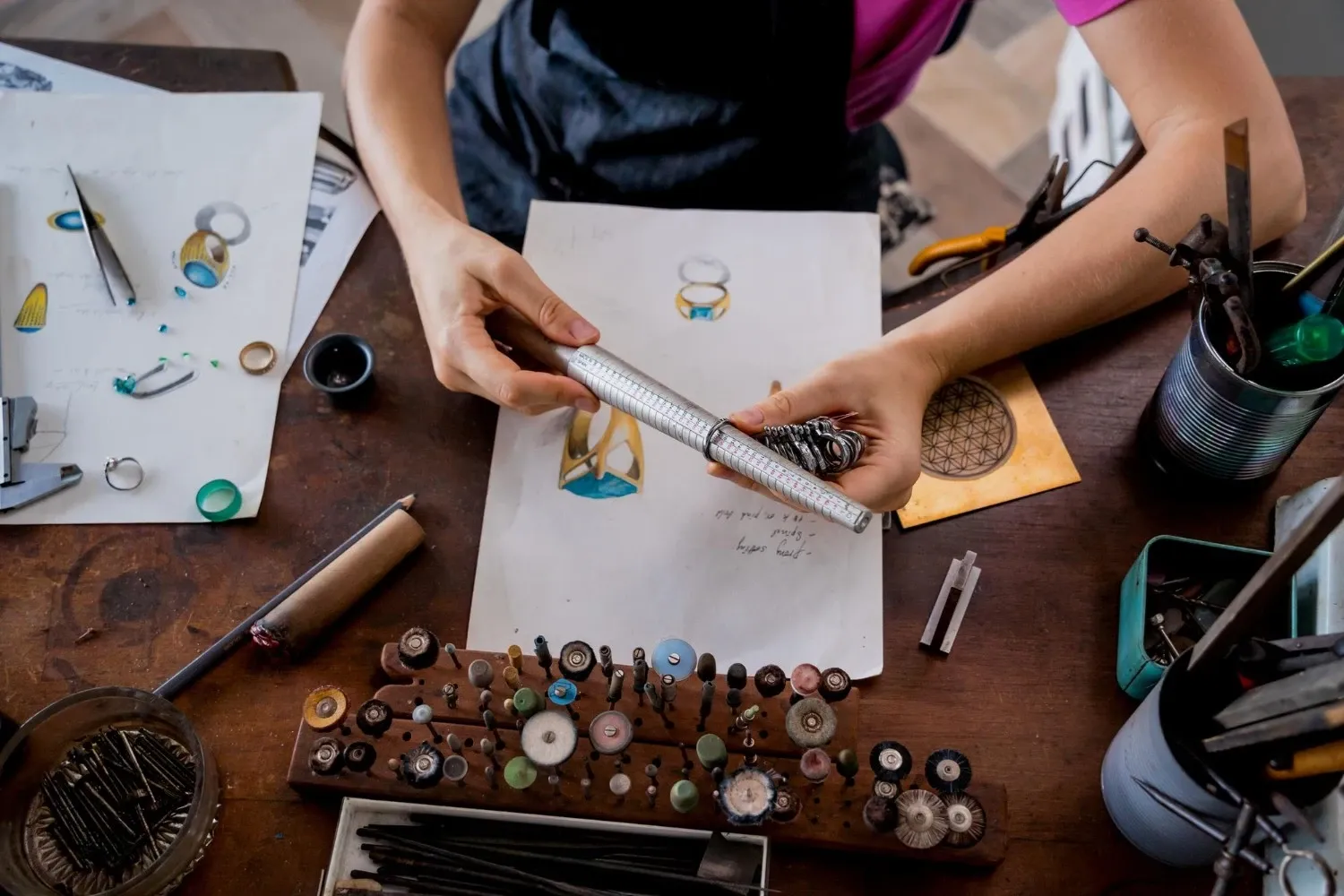 Young female jeweler making jewelry in workshop