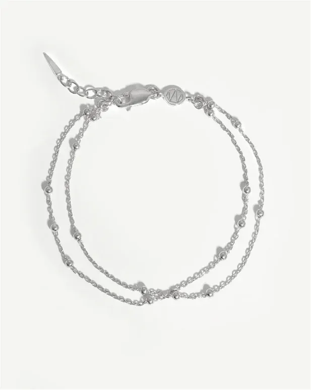 A delicate silver chain bracelet with small beads and a clasp