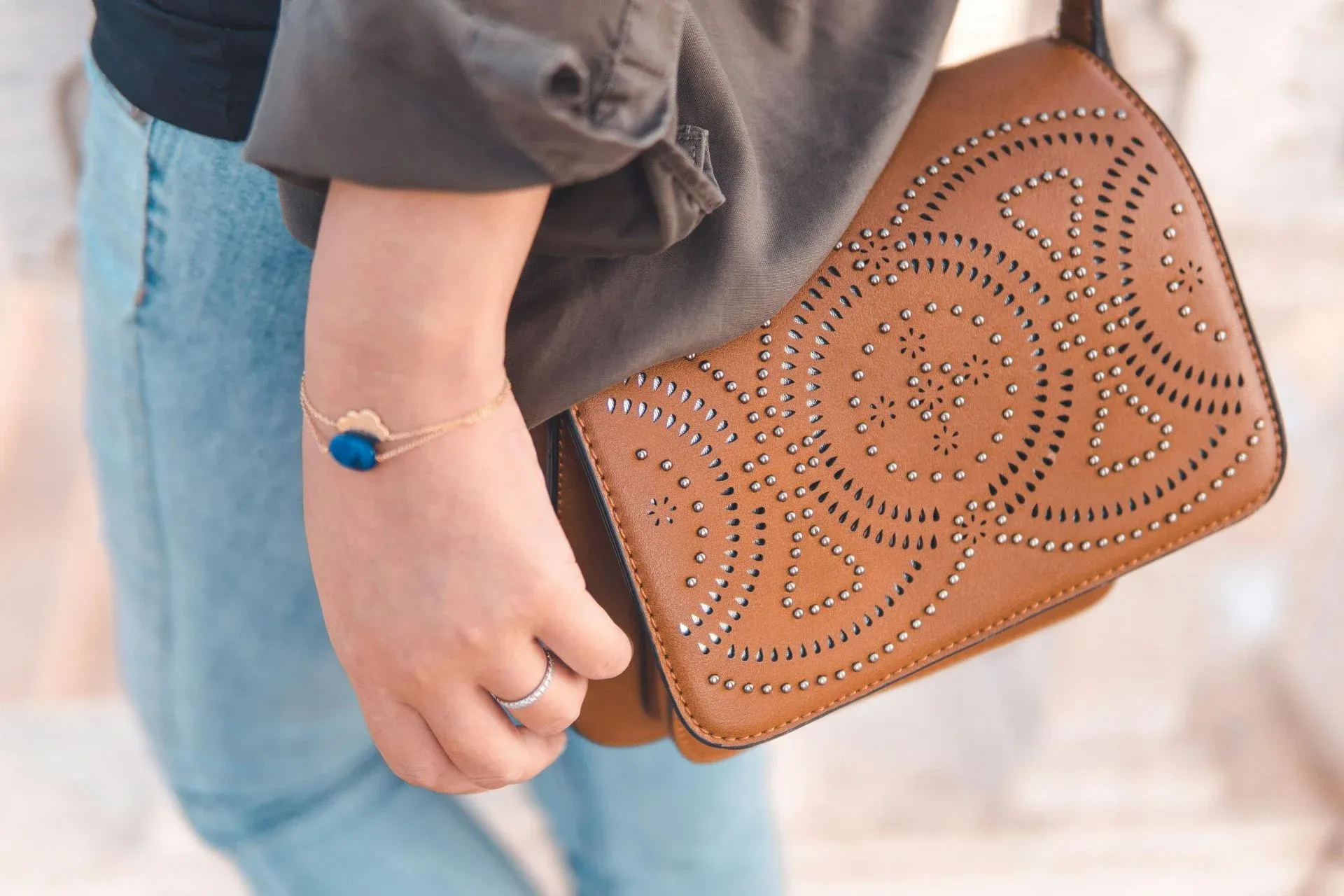 A person wearing a blue stone bracelet and a silver ring A person wearing a blue stone bracelet and a silver ring
