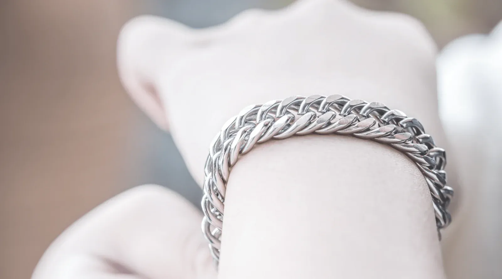 A stainless steel chain link bracelet on a wrist A stainless steel chain link bracelet on a wrist