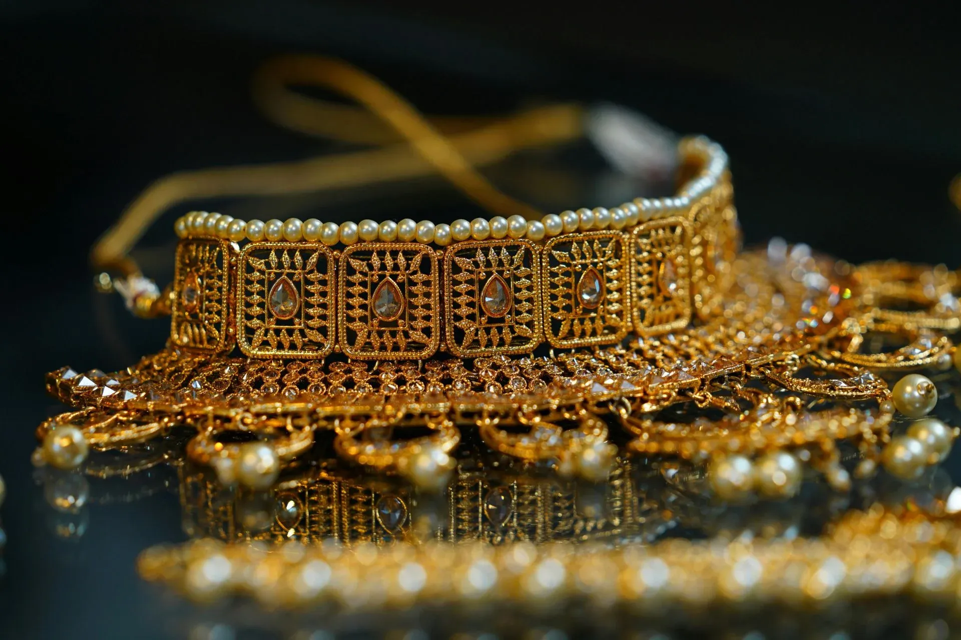 An ornate gold choker necklace adorned with intricate designs