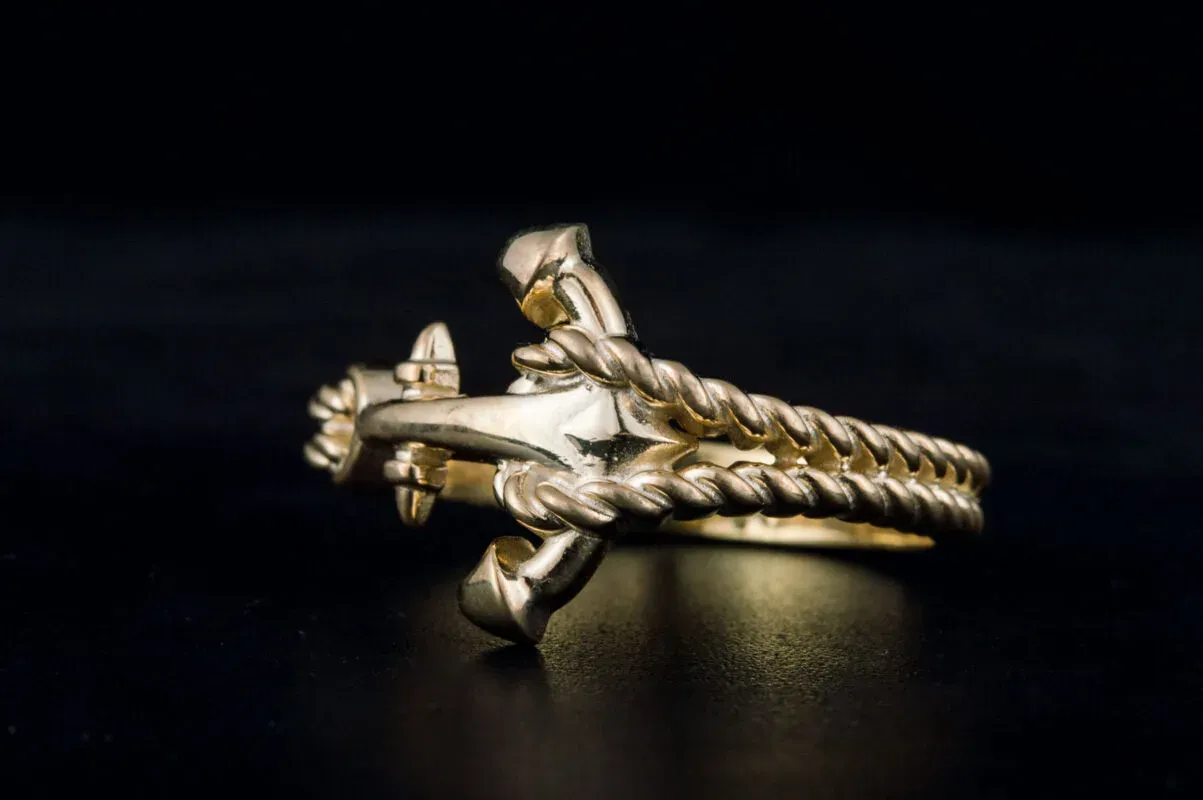 Close up of a gold and silver ring with an anchor design Close up of a gold and silver ring with an anchor design