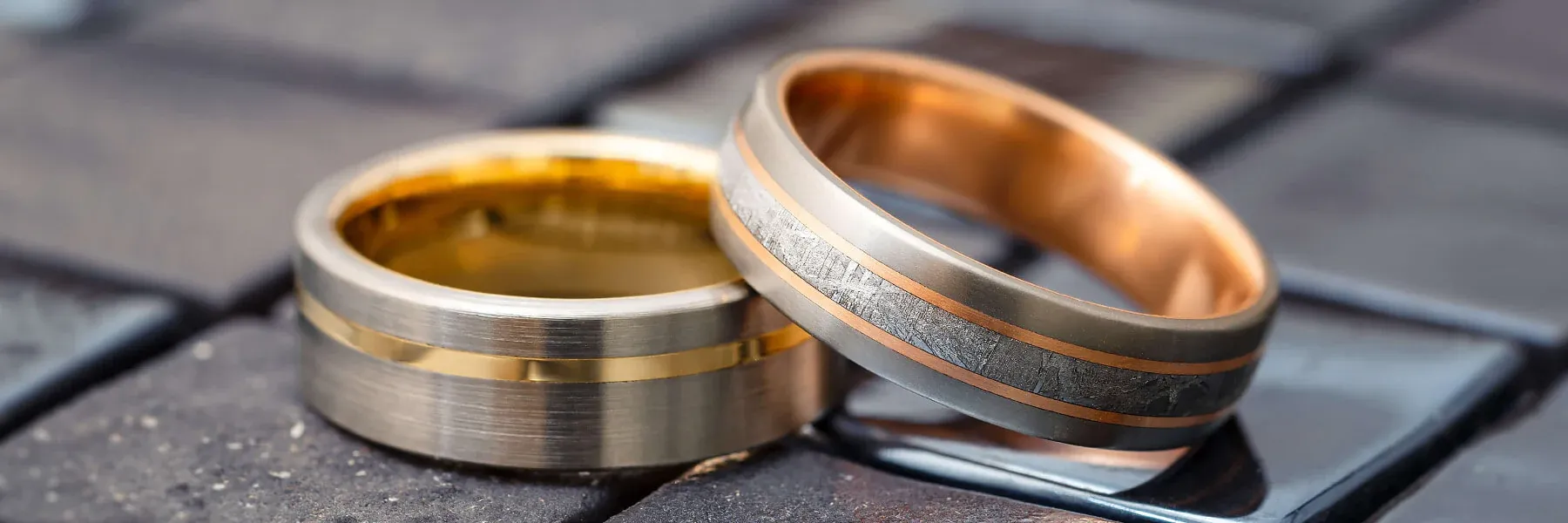 Two elegant metal rings featuring sleek designs with gold and copper accents Two elegant metal rings featuring sleek designs with gold and copper accents