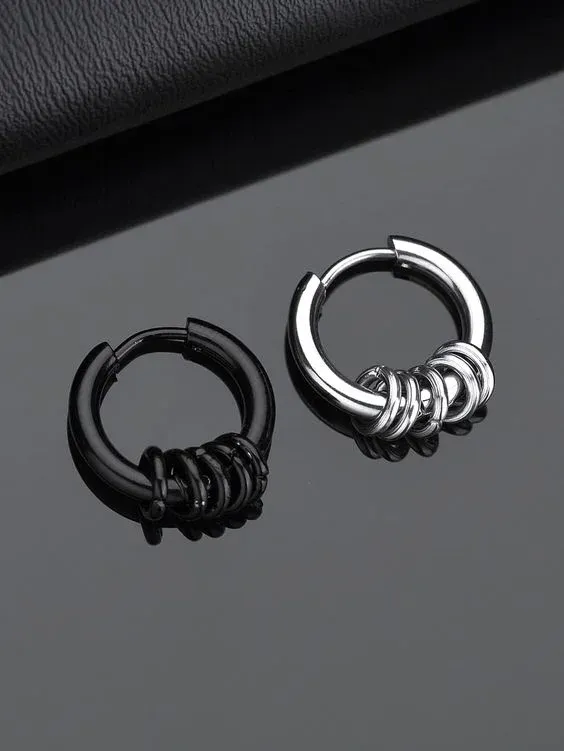 Two small hoop earrings on a black surface, one black and one silver Two small hoop earrings on a black surface, one black and one silver