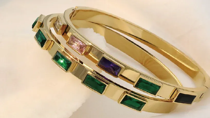bangles featuring rectangular gemstones in green, purple, pink, and black