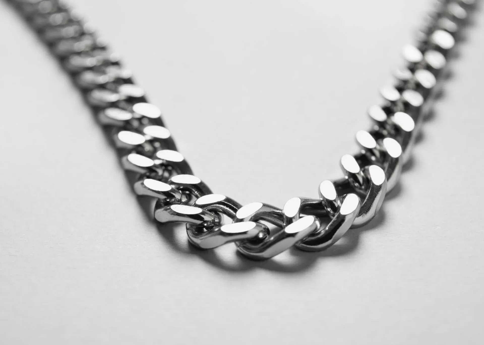 close up of a silver chain necklace with thick close up of a silver chain necklace with thick