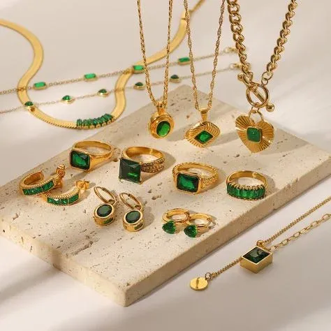 Gold jewelry collection with green gemstones, including necklaces, rings, and earrings Gold jewelry collection with green gemstones, including necklaces, rings, and earrings