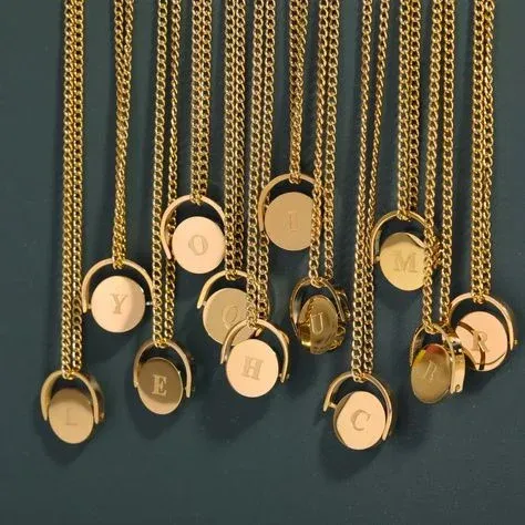 Gold necklaces with round pendants engraved with various letters