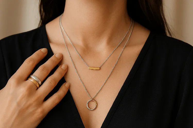 Trendy mixed metal jewelry with stacked rings and layered necklaces. Trendy mixed metal jewelry with stacked rings and layered necklaces.
