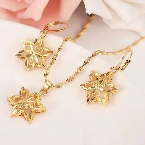 Gold necklace and earrings with star shaped pendants Gold necklace and earrings with star shaped pendants