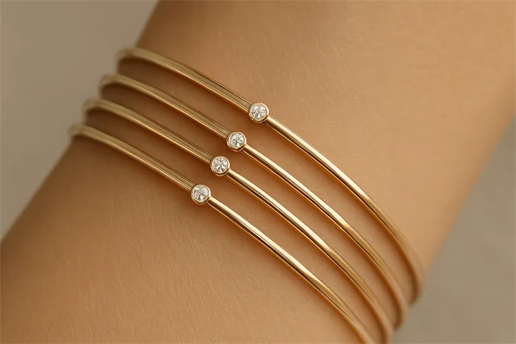 Slim stackable bracelets in gold, perfect for a delicate layered look Slim stackable bracelets in gold, perfect for a delicate layered look