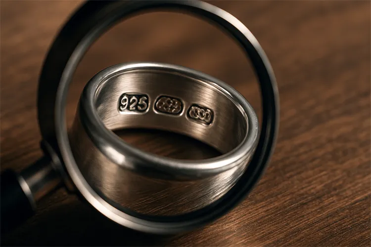 Using magnification to read silver jewelry hallmarks. Using magnification to read silver jewelry hallmarks.