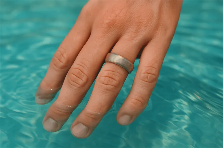 Silver ring in a pool showing water-induced damage. Silver ring in a pool showing water-induced damage.