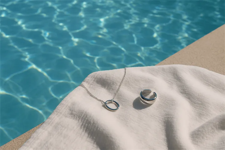 Silver jewelry near a tranquil pool with clear blue water. Silver jewelry near a tranquil pool with clear blue water.