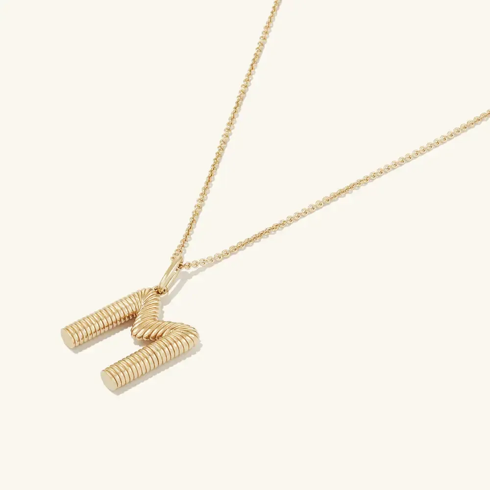 M pendant necklace with a ribbed cylindrical design