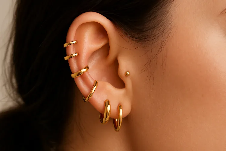 Different earring styles stacked on ear Different earring styles stacked on ear