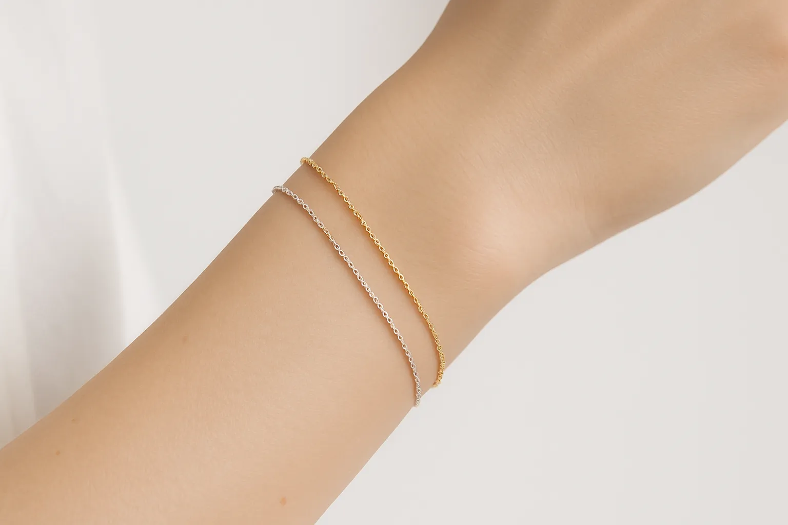 Permanent gold and silver bracelet on wrist