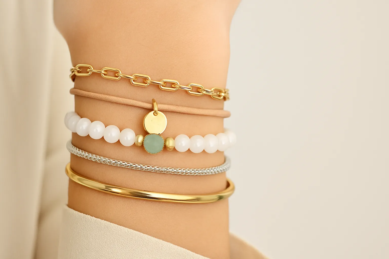 Chic bracelet stack with gold, silver, and gemstones.