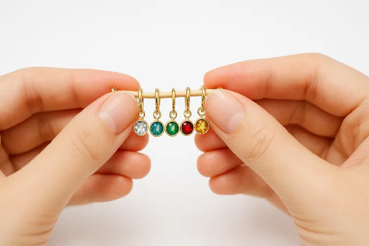 Hands holding personalized birthstone earrings Hands holding personalized birthstone earrings