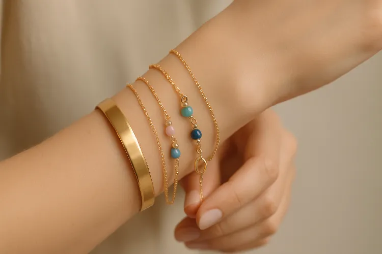 Delicate and bold bracelets layered on a wrist. Delicate and bold bracelets layered on a wrist.