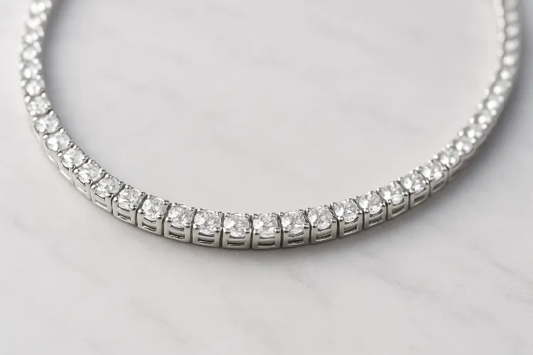 Close-up of a sleek tennis necklace with diamonds. Close-up of a sleek tennis necklace with diamonds.