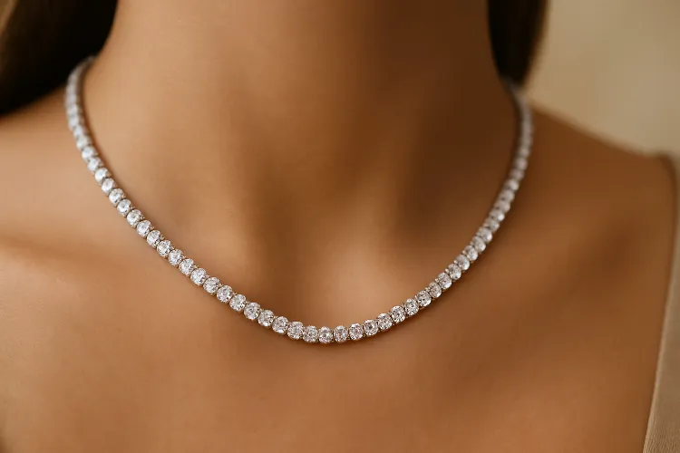 Tennis necklace sparkling on a model’s neck. Tennis necklace sparkling on a model’s neck.