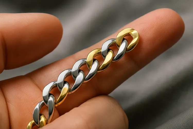 Hand holding stainless steel curb chain. Hand holding stainless steel curb chain.