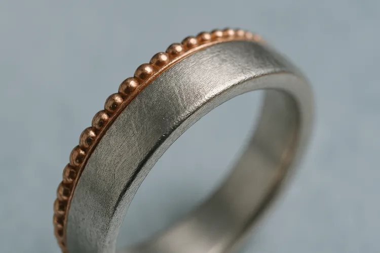 Worn rose gold ring on soft fabric Worn rose gold ring on soft fabric