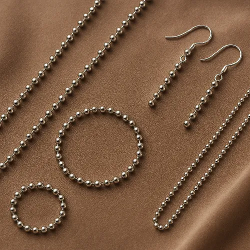Silver beaded chain set, including necklace, bracelet and earrings. Silver beaded chain set, including necklace, bracelet and earrings.