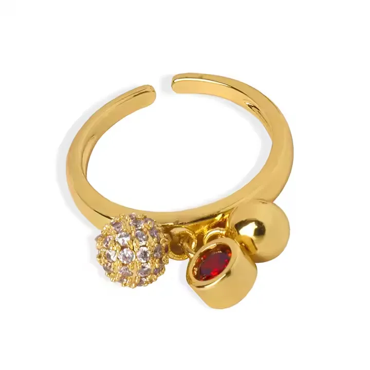 Copper charm ring with crystal red stone and gold ball