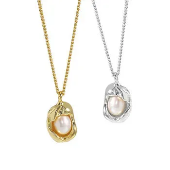 Organic pearl pendant in gold and silver plated settings