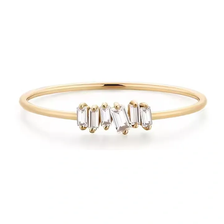 Thin gold ring with baguette cut gemstones