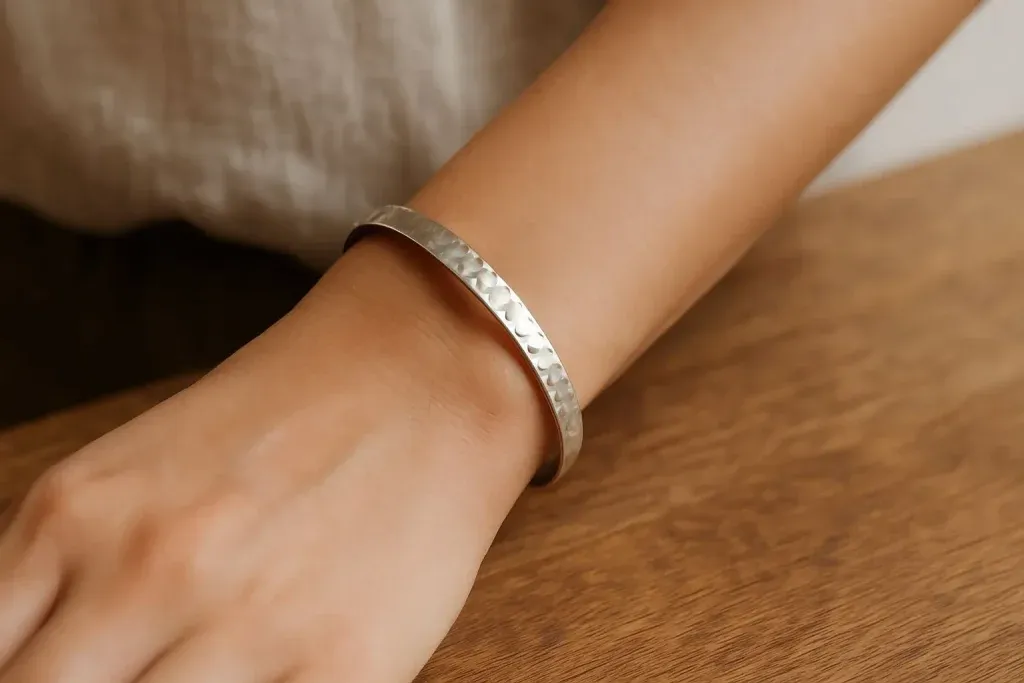 A detailed display of wearing a hammer textured bracelet