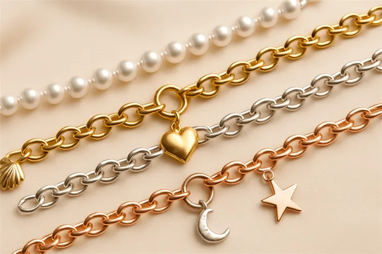 Different charm chain materials including gold, silver, and pearls