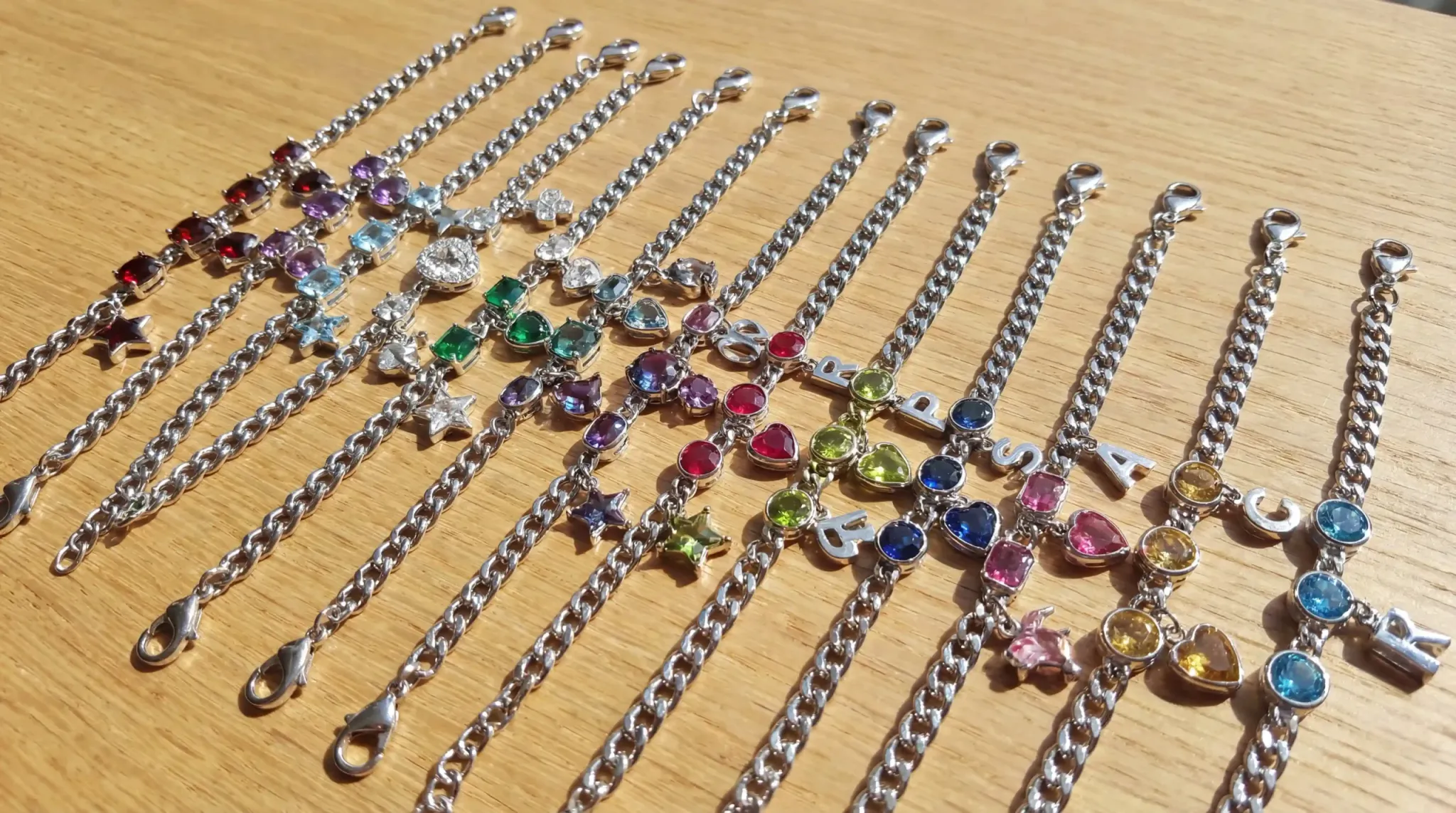 A child's stainless steel birthstone bracelet with a personalized charm and durable links