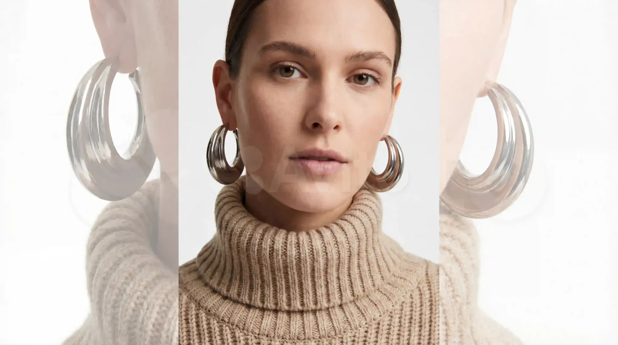 Large, mirror-polished 316L stainless steel hoops paired with a neutral ribbed turtleneck, demonstrating the power of sharp definition against heavy knits.