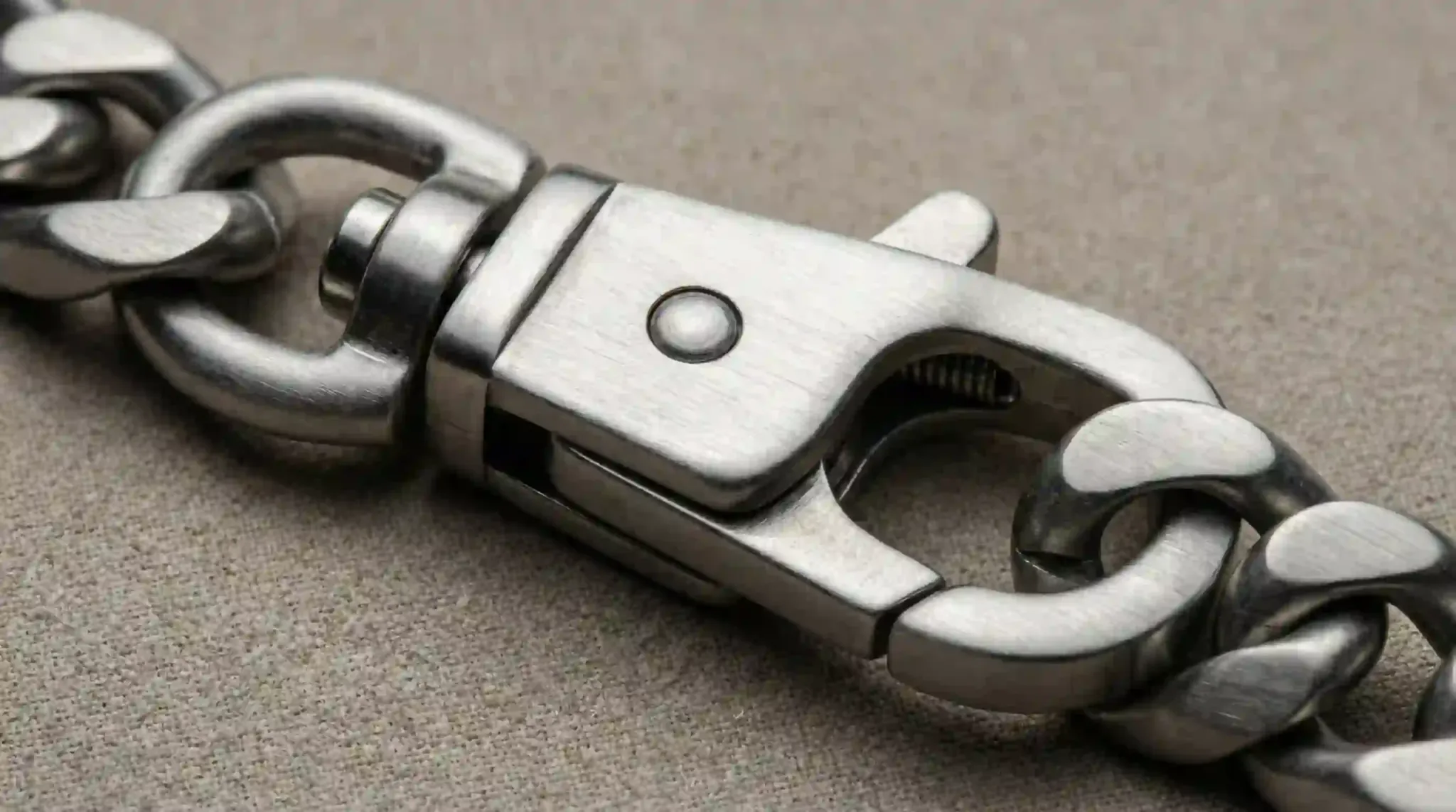 A heavy-duty stainless steel lobster clasp showing precision engineering