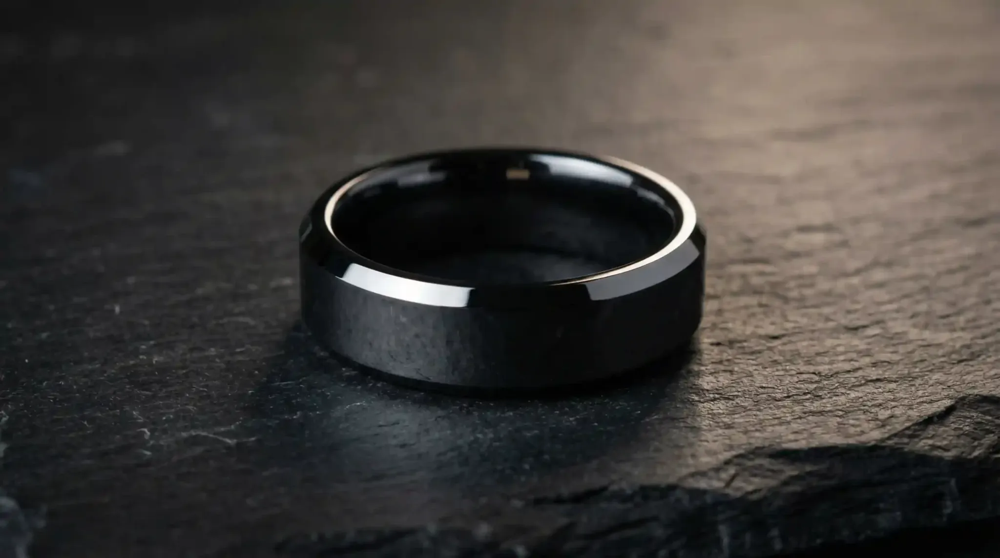 A high-detail macro shot of a polished tungsten carbide wedding ring